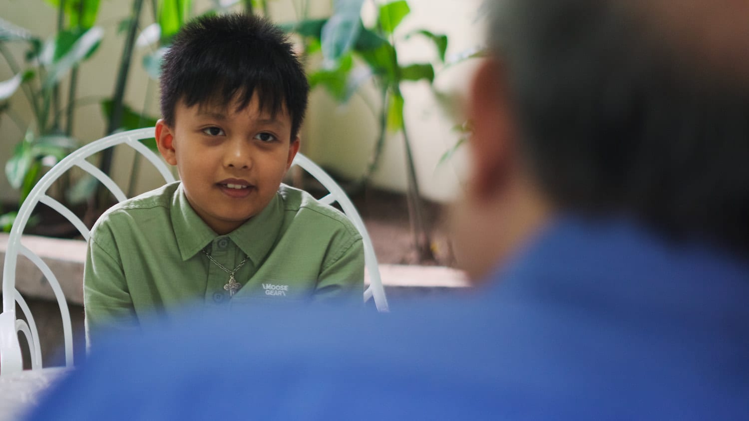 Young boy talks to his grandfather