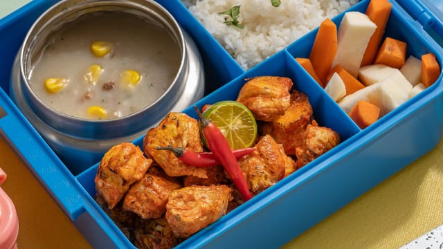 boneless chicken inasal bites in a blue bento box