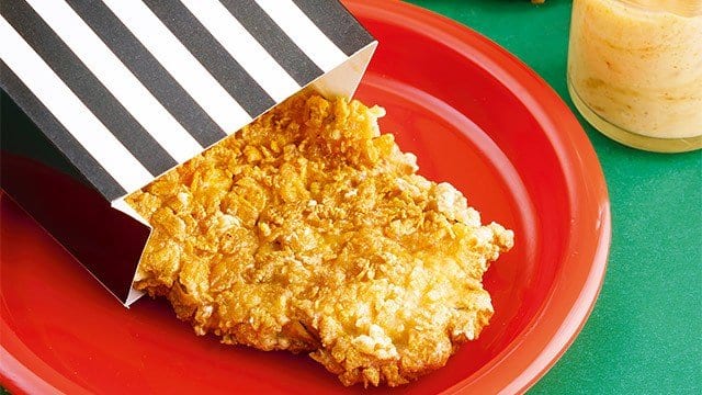  cereal-crusted fried chicken on a red plate