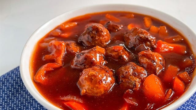 sweet and sour chicken meatballs in a white plate