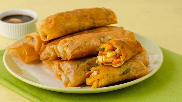 lumpiang gulay piled on a white plate