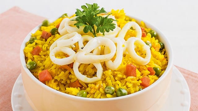 turmeric fried rice topped with squid