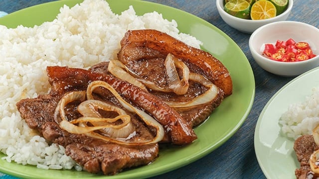 bistek pork chop with rice on a green plate