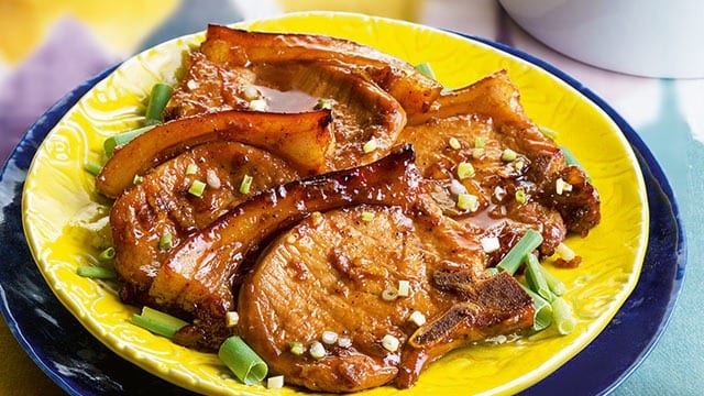 pan seared pork chops on a yellow plate