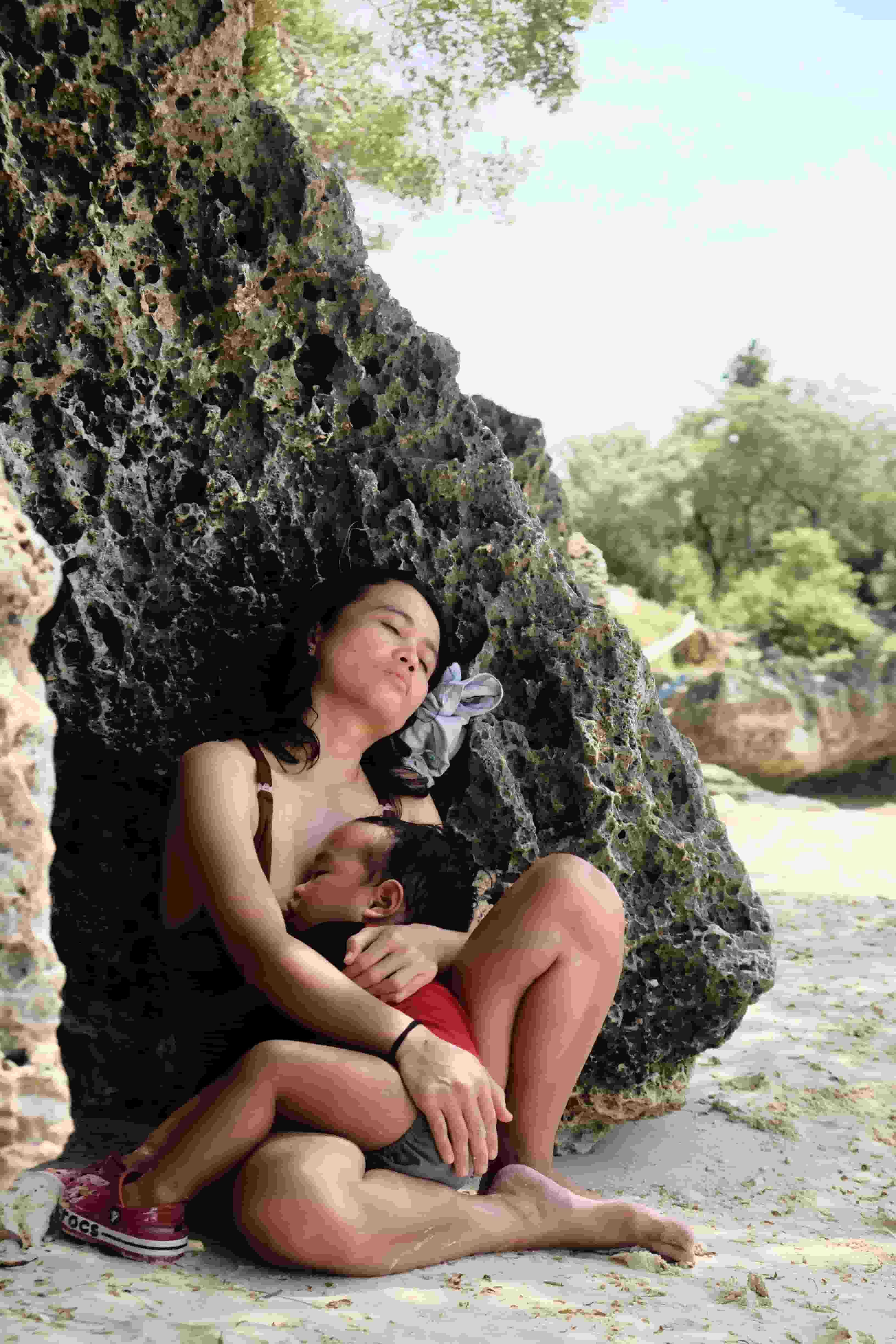 mother and child sleeping at the beach