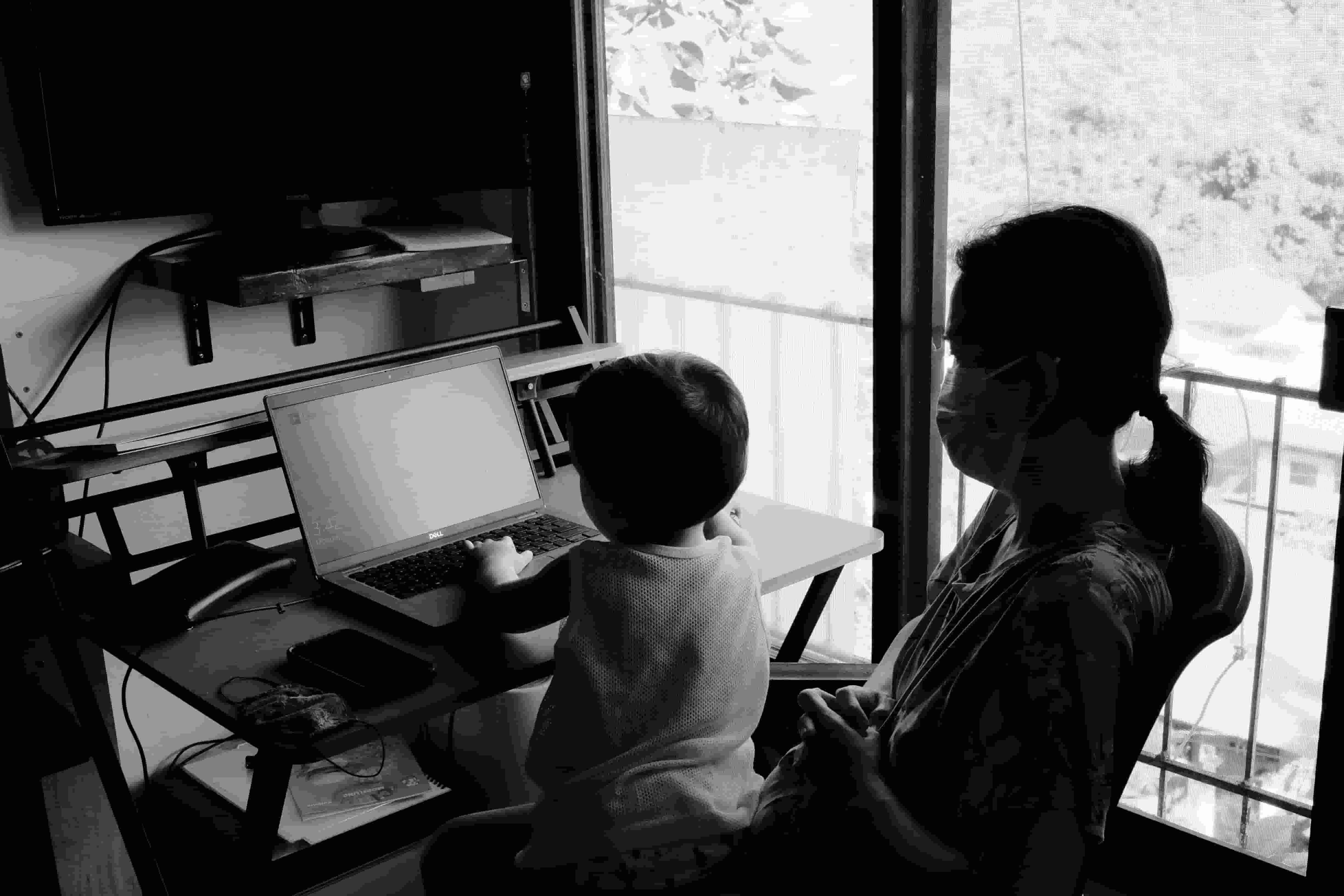 mother and child looking at a laptop