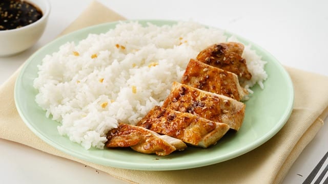 Chicken Teriyaki on a green plate served with rice