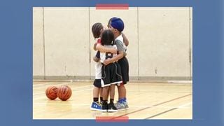 Kids Show One Another Some Love With A Group Hug At A Basketball Game!